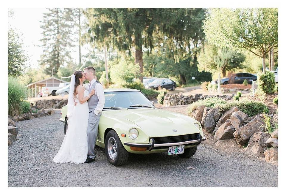 Newlyweds by vintage car