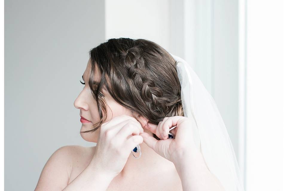 Bride wearing her earrings