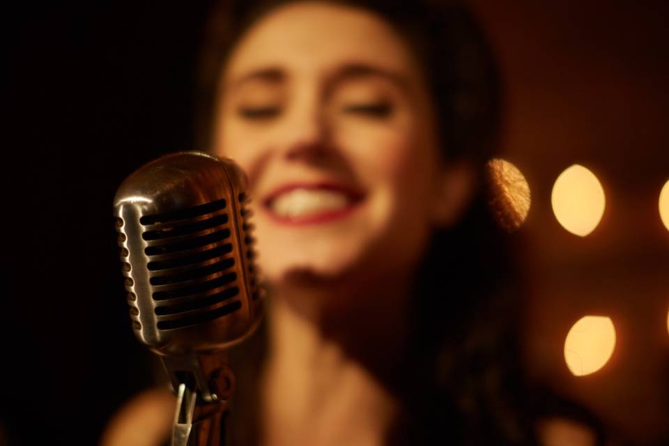 Woman singing into microphone