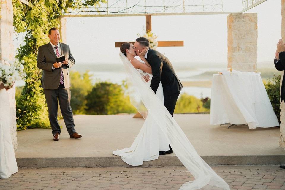 The couple kisses at their ceremony