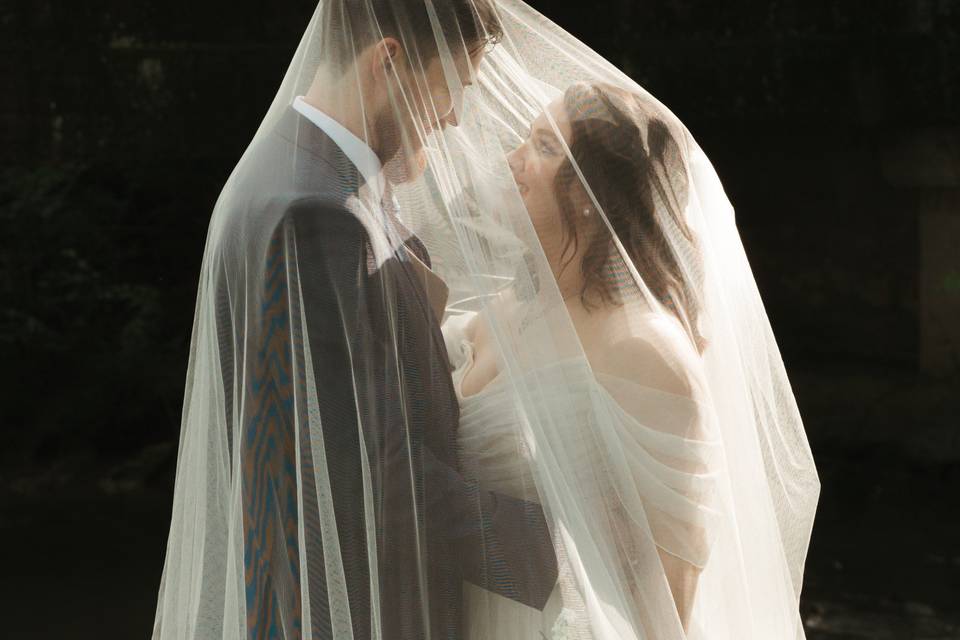 Bride and groom under veil