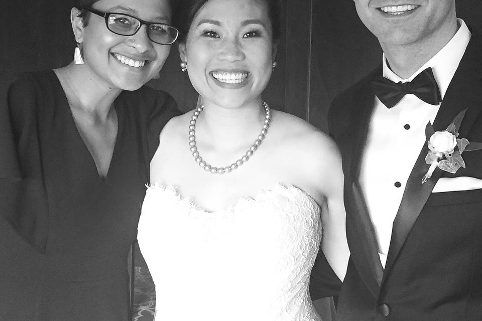 Wedding officiant with the bride and groom