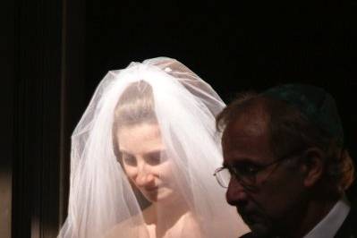 The bride had her own special light as she started down the aisle, escorted by her parents.