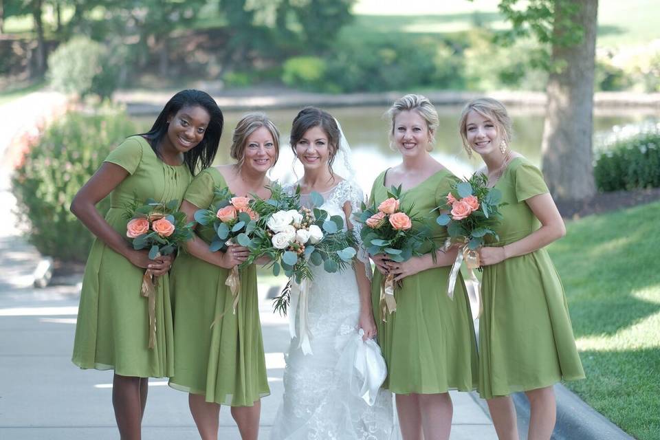 Bridesmaid's bouquet has peach roses with eucalyptus and podacarpus