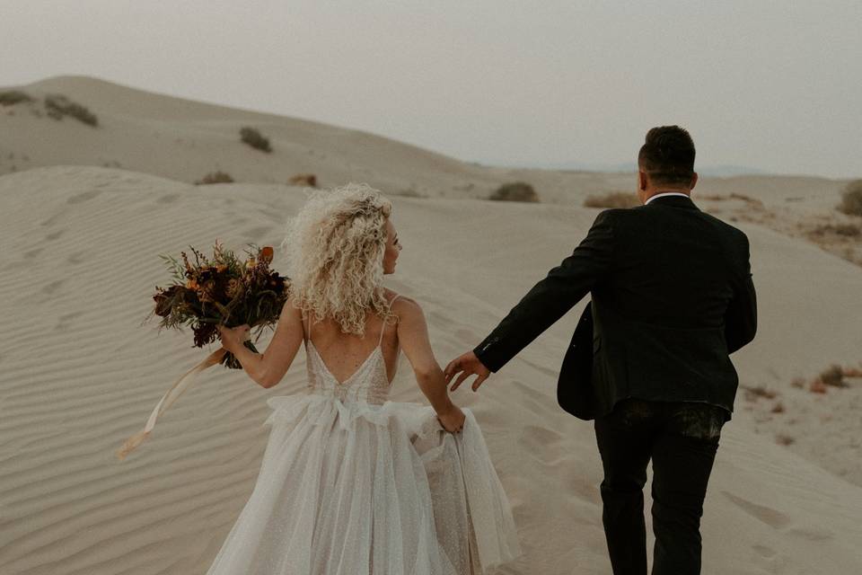 Bride and groom at sand dunes