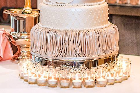 Elegant wedding cake, with edible gold flake floral pattern. Contains 216 servings. Everything is edible forms of cake, fondant and sugar.