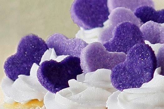 Vanilla cupcakes with vanilla buttercream and purple sugar hearts