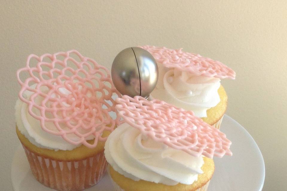 Vanilla cupcakes with vanilla butter cream and pink candy flowers