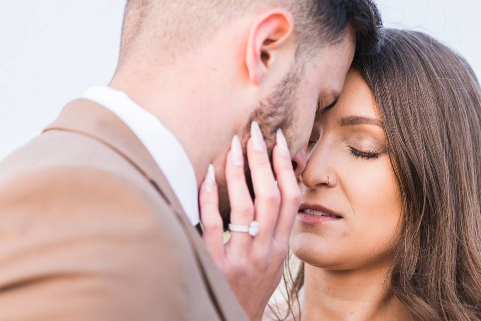 Couple kissing, wedding ring