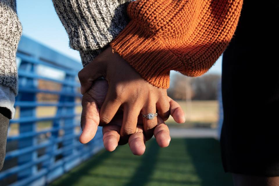 Holding hands on a bridge