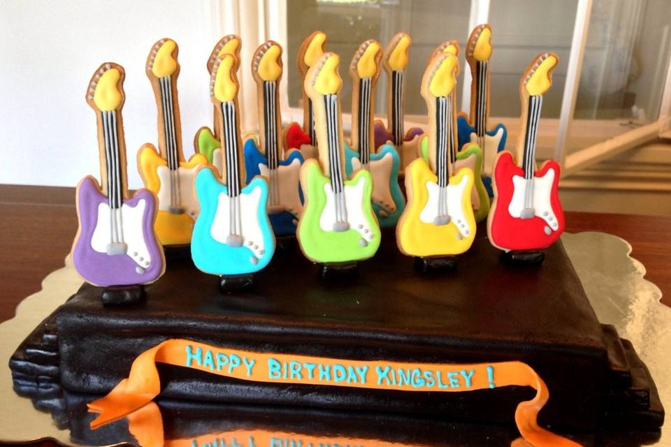 Our rock n' roll birthday boy loves guitars so we create a full set of guitar cookies and presented them on a delicious chocolate cake stage!