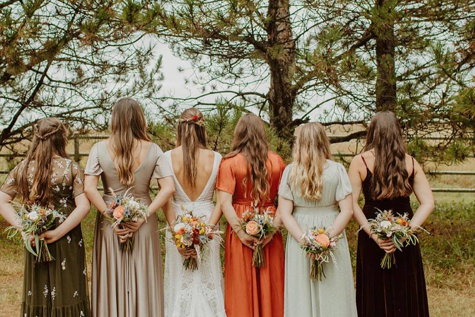 Wedding party in front of pine trees