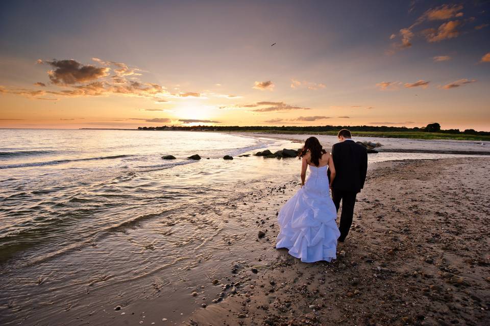 Newlyweds walking on the beach