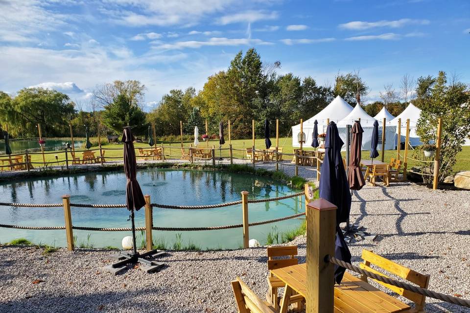 Pond seating with tent view