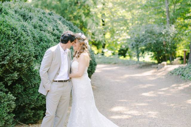 Newlyweds kiss by the trees