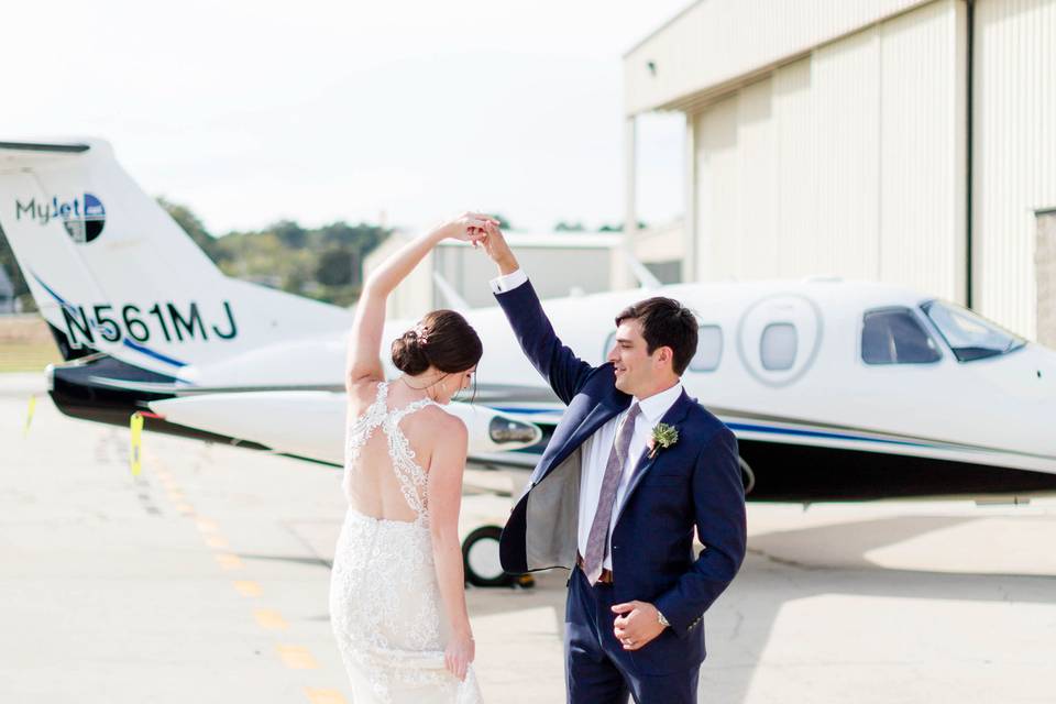Newlyweds by the private plane
