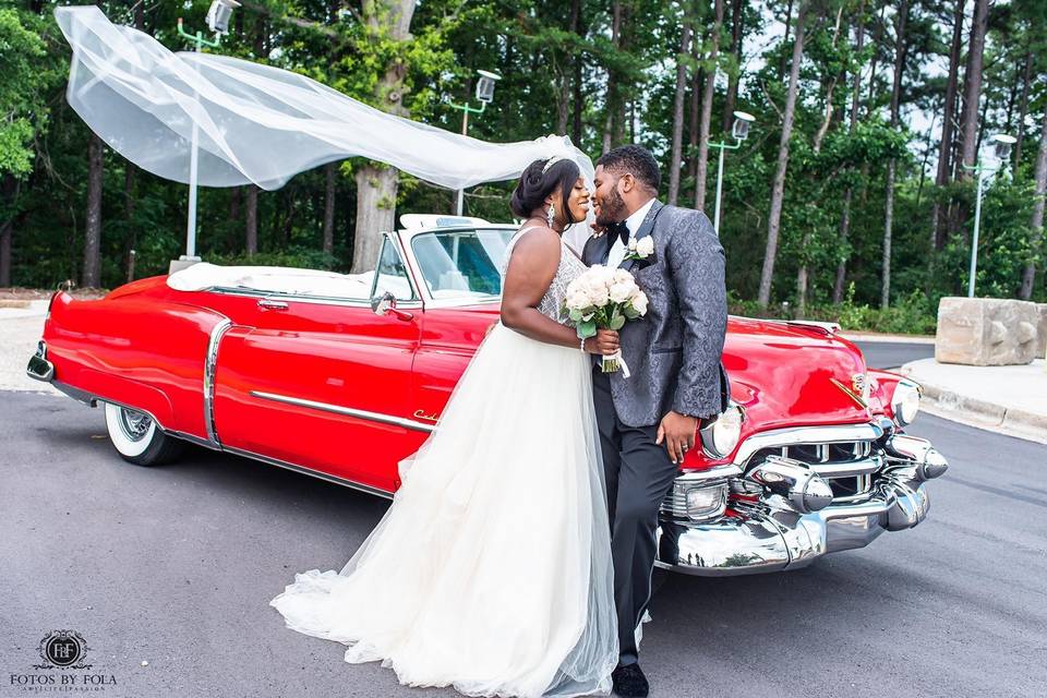 Newlyweds by the Vintage Car