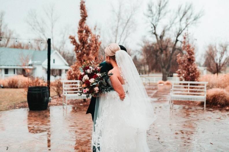 Bride holding bouquet by water