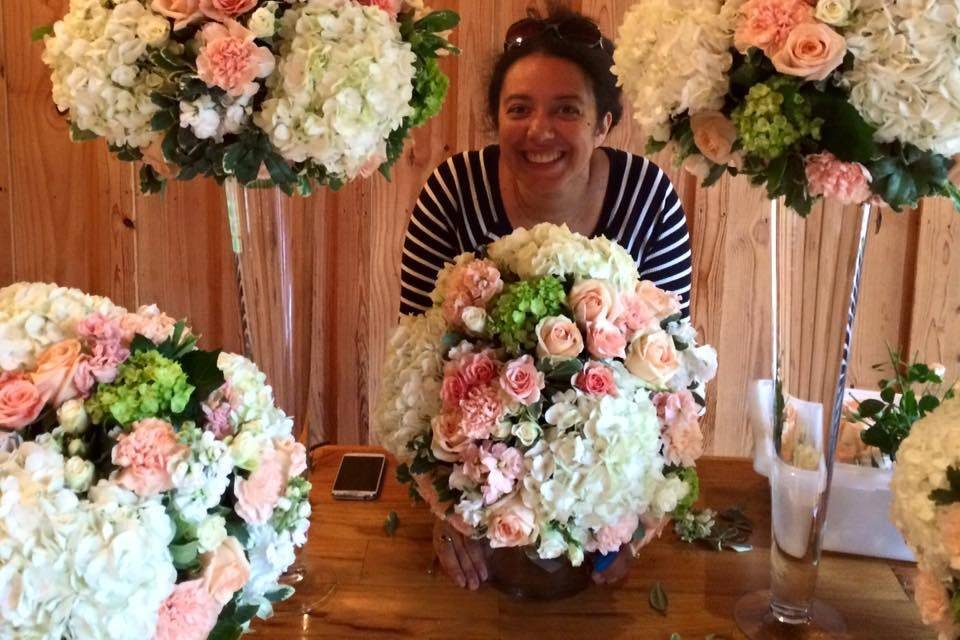 Tall centerpiece with white and peach flower arrangement