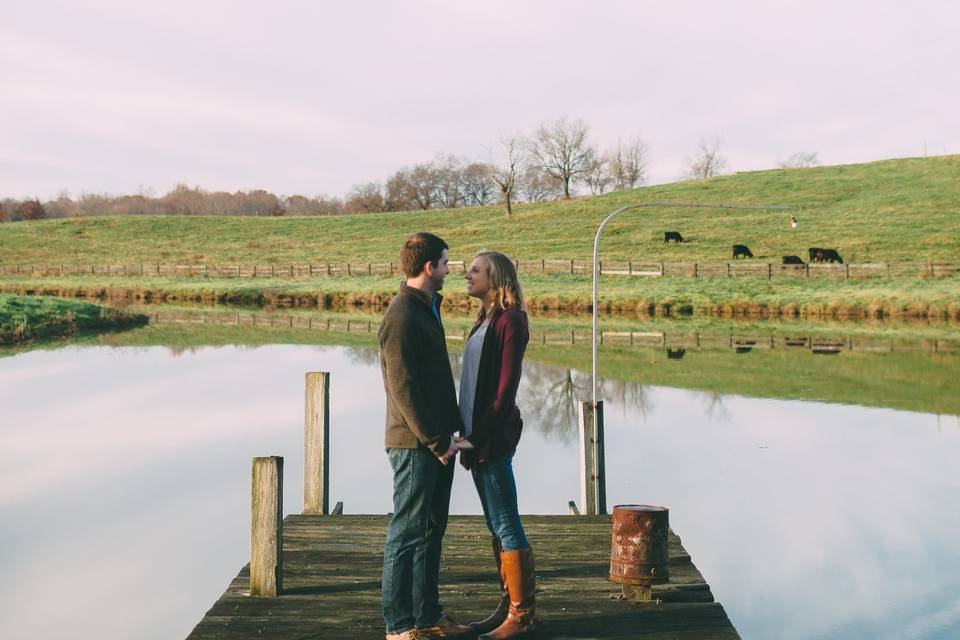 Couple celebrating their engagement by the stunning lake
