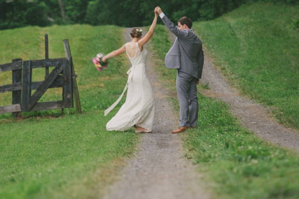 Newlyweds expressing happiness in the rolling hills
