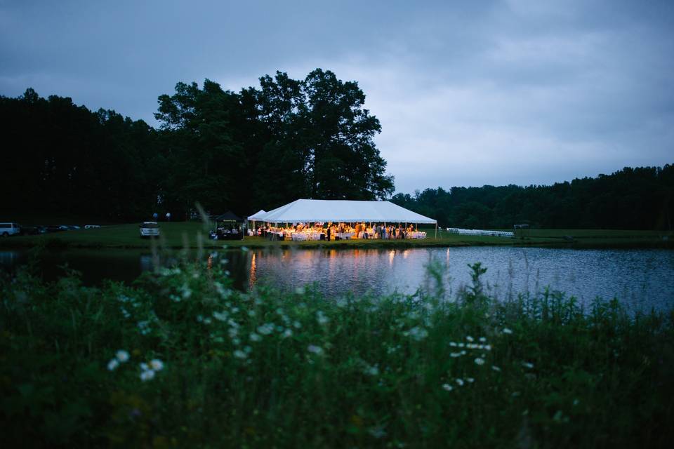 Private lakeside reception lighting up the evening