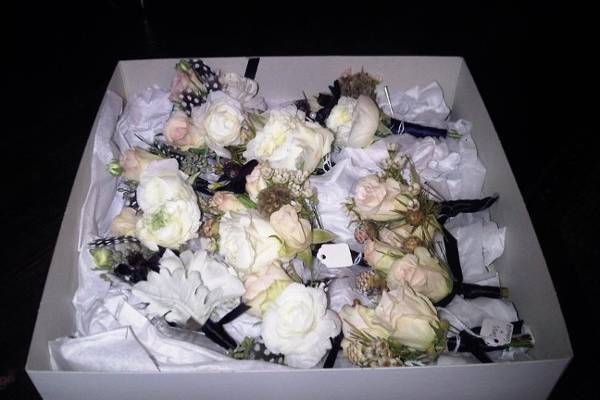 groomsmen boutonnieres, parents and grandparents corsages