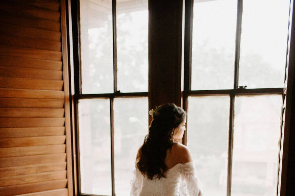 Bride looking out bridal suite