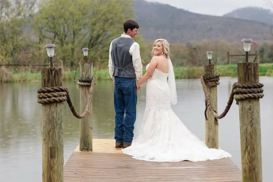 Couple's portrait on the dock, overlooking the pond