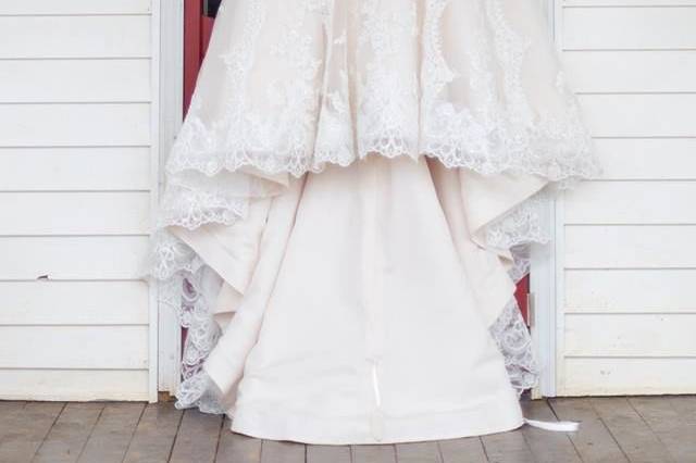 Wedding gown hanging on the front door of the farmhouse