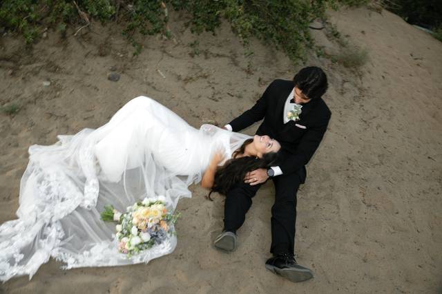 Bride groom laying on sand
