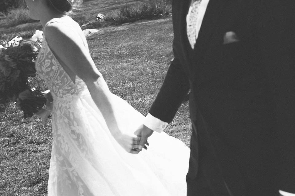 Bride and Groom walking meadow