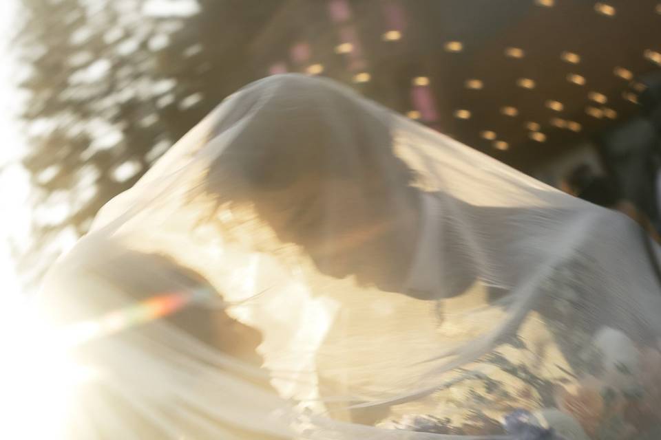 Bride groom veil sunset photo