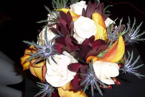 Woodland mix bouquet for white roses, sunset safari, blue thistle, and mango callas