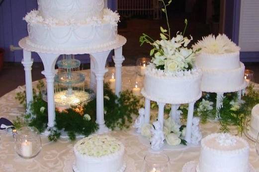 Heavenly Chocolate, White Velvet, Strawberries & Cream and Sunny Lemon layers, frosted with cream cheese butter frosting. Adorned with gumpaste azaleas,strands of ivory pearls, fresh flowers, candles and a fountain.