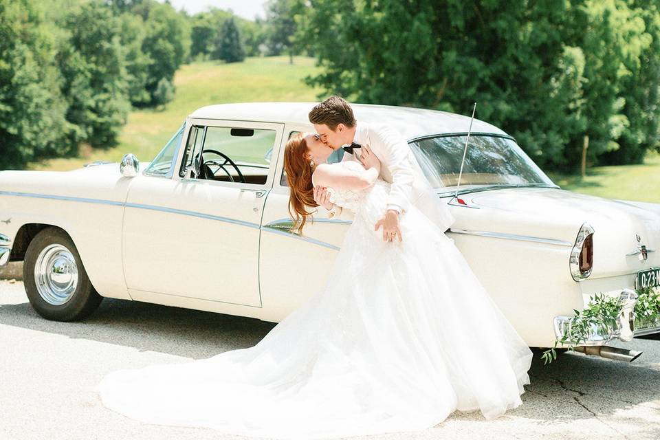 Couple in front of vintage car