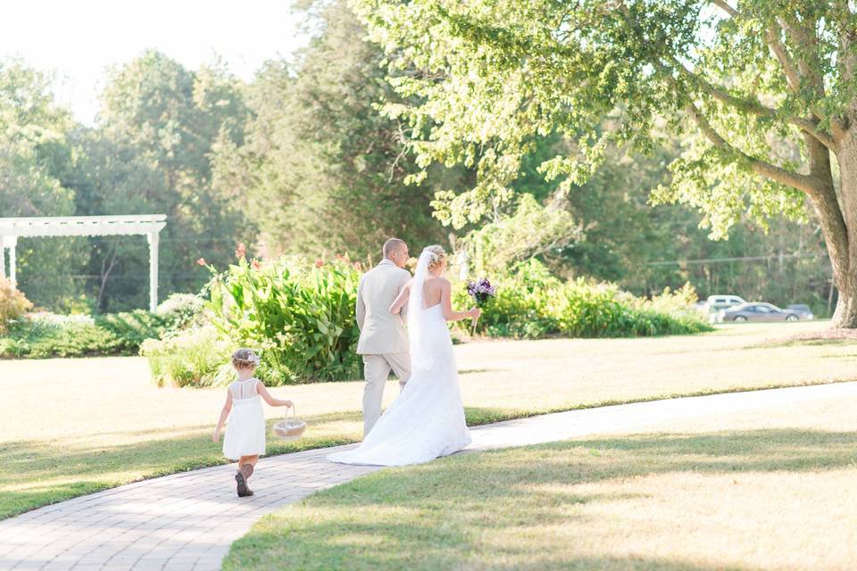 Bride and groom walking down a path