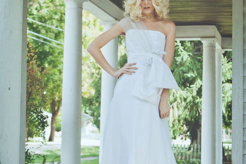 Style:11006 LAUREL Full length gown of silk voile with striped elastic shoulder strap. Taffeta bows and Lily of the Valley flowers at waist. Available in white only. 100% silk.