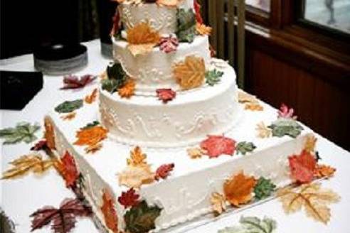 Fall theme with edible leaves, white with white scroll work, and a combo of square and circle cakes