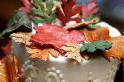 Close up of fall theme cake with edible leaves