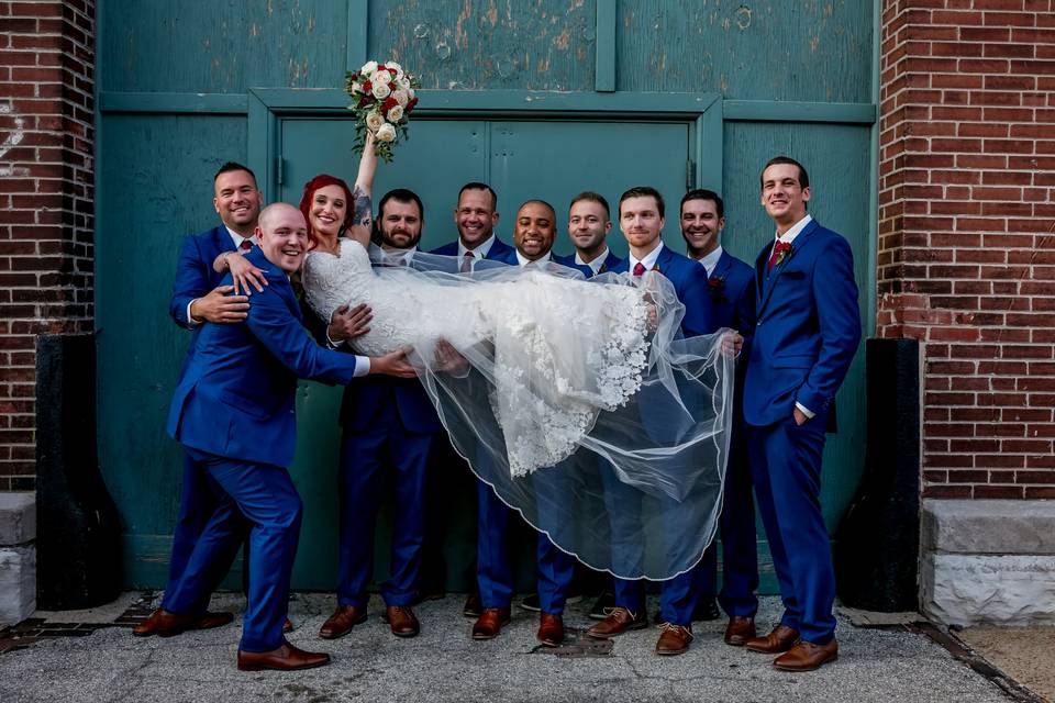 Groomsmen lifting bride