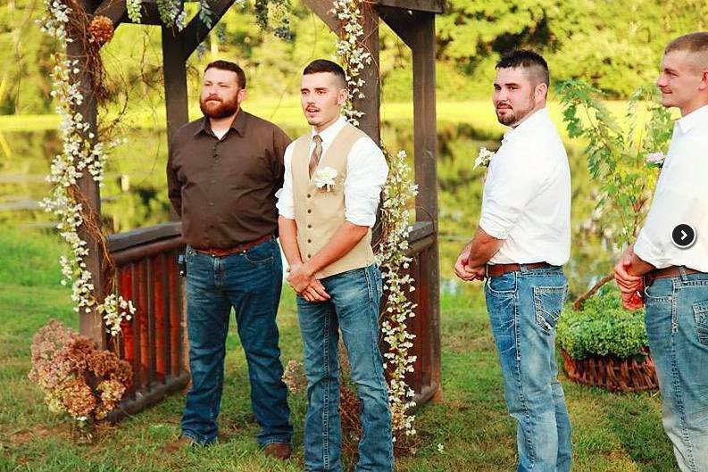 Groom with officiant and groomsmen