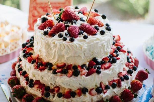 Three tier fruit wedding cake with strawberries and blueberries.  Americana Cake