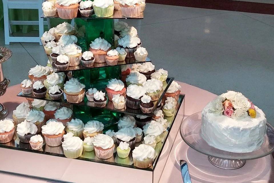 whimsical cupcake tower with cutting cakes