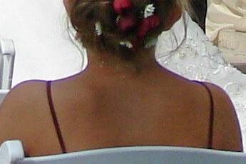 Burgundy spray roses & white monte  entwined in a fancy hairdo.