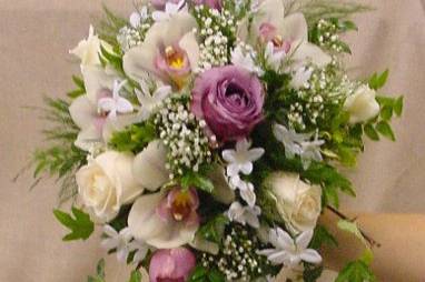 Bridal cascade of lavender & white roses, cymbidium orchids, stephanotis, & ivy.