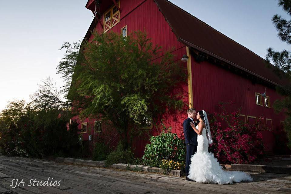 Newlyweds outside the barn