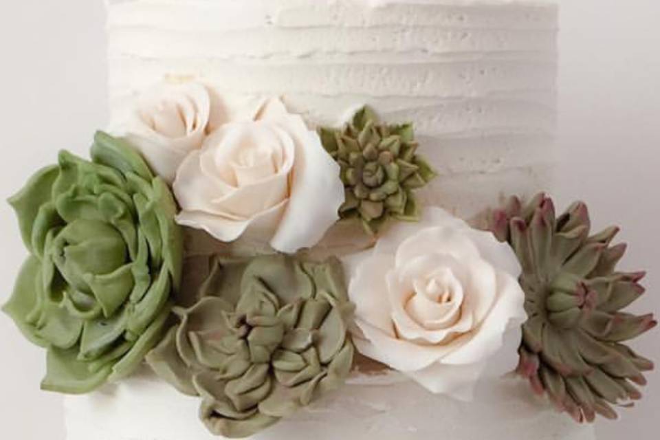 Buttercream cake with edible succulents and roses.