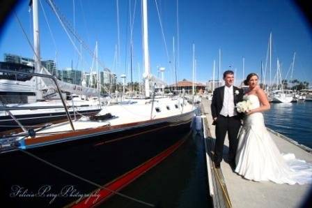 Newlyweds pose by the boat