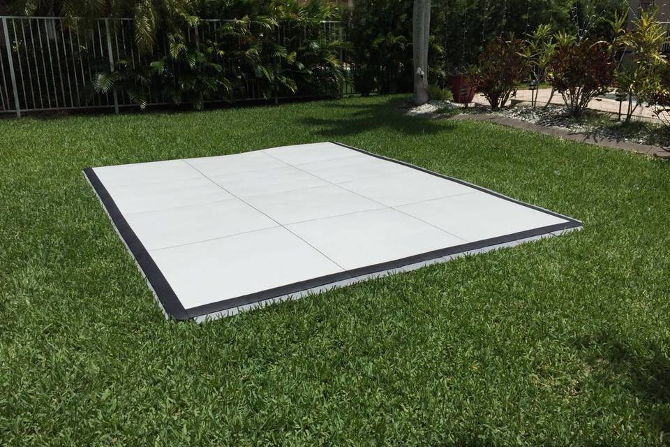 Dance floor set up on grass. White slate design.